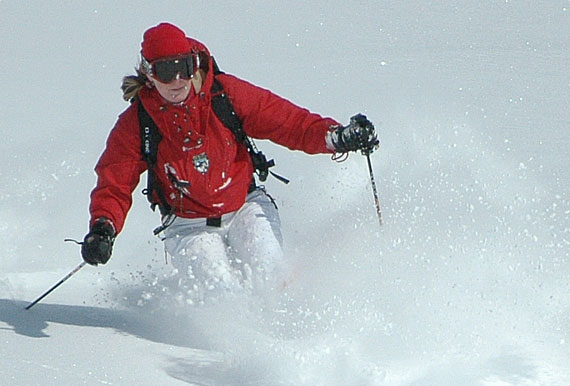 Skier skiing down a slope.